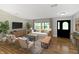 Inviting living room featuring hardwood floors, a comfortable sofa, and an abundance of natural light, creating a cozy atmosphere at 2935 N Grizzly Ln, Martinsville, IN 46151