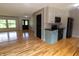 Open-concept kitchen and living room with hardwood flooring, white cabinets, and stainless steel appliances at 2935 N Grizzly Ln, Martinsville, IN 46151