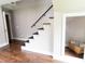 Modern staircase with dark steps and a black railing, complemented by hardwood flooring at 2935 N Grizzly Ln, Martinsville, IN 46151