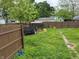 Backyard with patchy grass, wooden fence, trailer, and shed at 322 S Rural St, Indianapolis, IN 46201