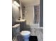 Bathroom featuring shower-tub, toilet, vanity, and wood-look flooring at 322 S Rural St, Indianapolis, IN 46201