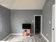 Bedroom featuring hardwood floors, with gray walls, and a television on a tv stand at 322 S Rural St, Indianapolis, IN 46201