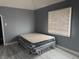 Bedroom with gray walls, light floor, and window offering lots of natural light at 322 S Rural St, Indianapolis, IN 46201