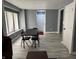 The dining area shows a gray color scheme, hardwood flooring, and natural light from the windows at 322 S Rural St, Indianapolis, IN 46201