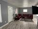 Living room with gray walls, light-colored floors, comfortable seating and nice lamps at 322 S Rural St, Indianapolis, IN 46201