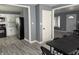 View of Kitchen from living room, featuring stainless fridge, gray walls, and white trim at 322 S Rural St, Indianapolis, IN 46201