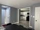 View of a kitchen, with stainless steel appliances and white cabinets, from living room at 322 S Rural St, Indianapolis, IN 46201