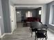 Open-concept living room featuring hardwood floors and neutral paint colors with a connecting dining room at 322 S Rural St, Indianapolis, IN 46201