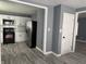View of a kitchen, with stainless steel appliances and white cabinets, from living room at 322 S Rural St, Indianapolis, IN 46201