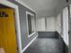 Inviting enclosed porch with abundant natural light, gray paint, and new windows at 322 S Rural St, Indianapolis, IN 46201
