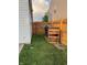 View of the backyard between two houses featuring a trash can and wooden fence at 3292 Underwood Dr, Whiteland, IN 46184