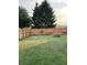 Fenced backyard with lush lawn is surrounded by mature trees and offers privacy at 3292 Underwood Dr, Whiteland, IN 46184