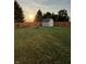Spacious backyard with a shed, fire pit, and wooden fence at 3292 Underwood Dr, Whiteland, IN 46184