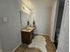 Bathroom with a stylish single vanity, modern lighting, and a decorative rug at 3292 Underwood Dr, Whiteland, IN 46184