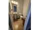 Bathroom features a simple pedestal sink, toilet, and tiled floors at 3292 Underwood Dr, Whiteland, IN 46184