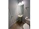 Charming half bathroom with a pedestal sink, a decorative mirror, and a tiled floor at 3292 Underwood Dr, Whiteland, IN 46184