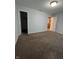 Bedroom with neutral walls and carpeted floors. A closet and another room are visible at 3292 Underwood Dr, Whiteland, IN 46184