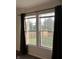 Bedroom window with views of the backyard and dark curtains at 3292 Underwood Dr, Whiteland, IN 46184