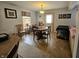 Cozy dining area featuring a round wooden table, natural light, and charming decor at 3292 Underwood Dr, Whiteland, IN 46184