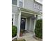 Welcoming front entrance with a dark door, flowers, and well-maintained landscaping at 3292 Underwood Dr, Whiteland, IN 46184
