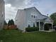 Side view of a well-maintained two-story home featuring a spacious lawn and a wood fence at 3292 Underwood Dr, Whiteland, IN 46184