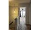 Upstairs hallway leading to a bedroom with a ceiling fan and natural light at 3292 Underwood Dr, Whiteland, IN 46184