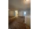 Hallway featuring a half bath and view into carpeted bedroom at 3292 Underwood Dr, Whiteland, IN 46184
