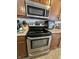 Stainless steel oven and microwave, accented by dark wood cabinetry and neutral countertops at 3292 Underwood Dr, Whiteland, IN 46184