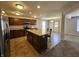 Modern kitchen featuring a central island with counter seating, dark wood cabinets, and stainless steel appliances at 3292 Underwood Dr, Whiteland, IN 46184
