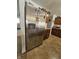 Kitchen with stainless steel refrigerator, dark wood cabinets, and neutral tiled flooring at 3292 Underwood Dr, Whiteland, IN 46184