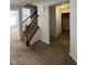 Carpeted staircase with wooden handrails, connecting the home's levels and adding architectural appeal with natural wood at 3292 Underwood Dr, Whiteland, IN 46184