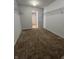 Carpeted walk-in closet showcasing ample shelving for organized storage at 3292 Underwood Dr, Whiteland, IN 46184