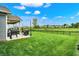 View of the outdoor grilling area, covered patio, and fenced-in backyard offering space and privacy at 3592 Gillsland Rd, Bargersville, IN 46106