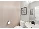 Powder room featuring a white sink, toilet, decorative mirror and wallpaper at 3592 Gillsland Rd, Bargersville, IN 46106