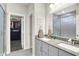 Bright bathroom with a double sink vanity, gray cabinets and a walk-in closet in the background at 3592 Gillsland Rd, Bargersville, IN 46106