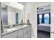 Bright bathroom featuring a double sink vanity, gray cabinets, and decorative mirror at 3592 Gillsland Rd, Bargersville, IN 46106