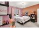 Stylish bedroom featuring a unique light fixture, neutral walls, and plush carpet at 3592 Gillsland Rd, Bargersville, IN 46106
