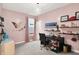 Bright bedroom with pink walls, desk, and decor, creating a whimsical and inviting space at 3592 Gillsland Rd, Bargersville, IN 46106