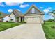 This single-Gathering home has a well manicured lawn, light brick exterior, and a two car garage at 3592 Gillsland Rd, Bargersville, IN 46106