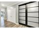 Hallway with a view into another room featuring wood floors and a decorative sliding closet door at 3592 Gillsland Rd, Bargersville, IN 46106