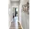 Hallway with wood floors that leads to a room with bright light and scenic view at 3592 Gillsland Rd, Bargersville, IN 46106