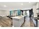 Open-concept kitchen with an island, modern appliances, and seamless flow to the dining and living spaces at 3592 Gillsland Rd, Bargersville, IN 46106