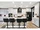 Stylish kitchen boasts white cabinets, a center island with seating, and sleek black appliances at 3592 Gillsland Rd, Bargersville, IN 46106