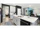 Modern kitchen island with a sink and dishwasher, bar seating, and open access to the living room area at 3592 Gillsland Rd, Bargersville, IN 46106