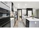 Modern kitchen featuring white cabinetry, stainless steel appliances, and an island with quartz countertops at 3592 Gillsland Rd, Bargersville, IN 46106