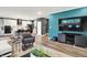 Open-concept living room featuring modern furnishings, sleek hardwood floors, and a statement blue accent wall at 3592 Gillsland Rd, Bargersville, IN 46106