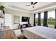 Open main bedroom with a flatscreen TV, multiple windows with a backyard view, and tray ceiling at 3592 Gillsland Rd, Bargersville, IN 46106