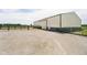 Exterior view of the barn, gravel driveway, black fences, and green grass at 3642 S Mauxferry Rd, Franklin, IN 46131