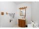 Bathroom featuring a wooden vanity with sink, a mirror with lights, and accessible grab bars at 3642 S Mauxferry Rd, Franklin, IN 46131