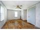 This bedroom features wood floors, wallpaper, a ceiling fan, and natural light at 3642 S Mauxferry Rd, Franklin, IN 46131